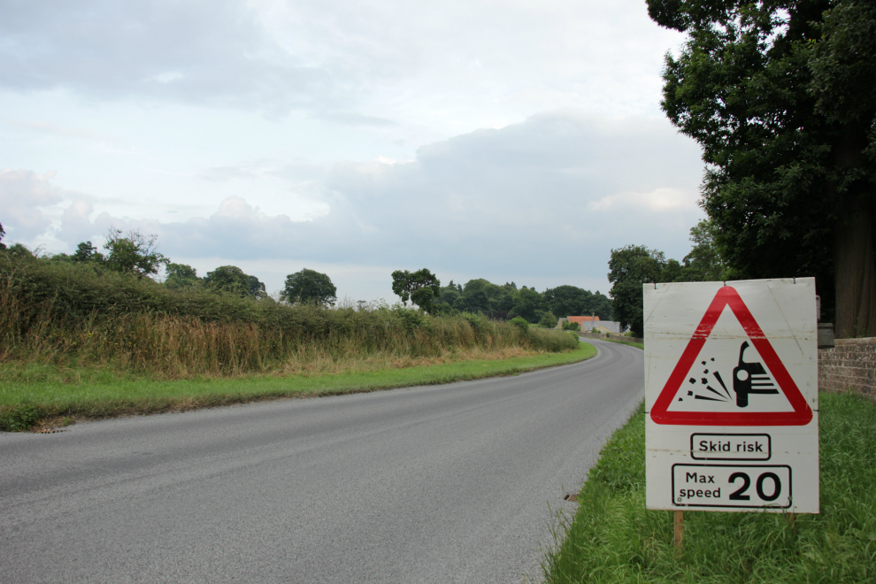 Loose chippings Skid risk Max 20mph sign