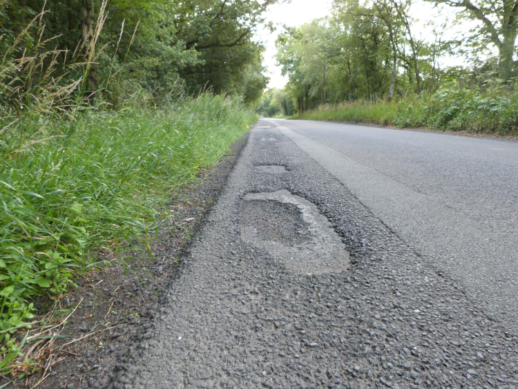 Poor road surface on Penny Pot Lane, Harrogate Poor road surface on Penny Pot Lane, Harrogate