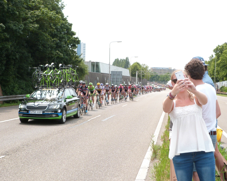 A spectator takes a selfie in front of the peloton A spectator takes a selfie in front of the peloton